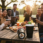 A backyard party scene shows several people gathered around a table, smiling and celebrating with CooCoo Cups® in hand. One cup on the table lies on its side, revealing a bottom sticker featuring a charismatic man holding a beer and raising a toast.