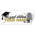 A customizable graduation-themed banner with a black graduation cap, gold and black script text reading 'con-grad-utations', large gold placeholder text 'YOUR NAME', a placeholder circle photo area and a curled lower-right corner.