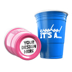 Two CooCoo Cups® are shown, one blue and one pink. One displays the white text “Woohoo! It's a...” while the other lies on its side, revealing a customizable bottom sticker labeled “Your Design Here.”