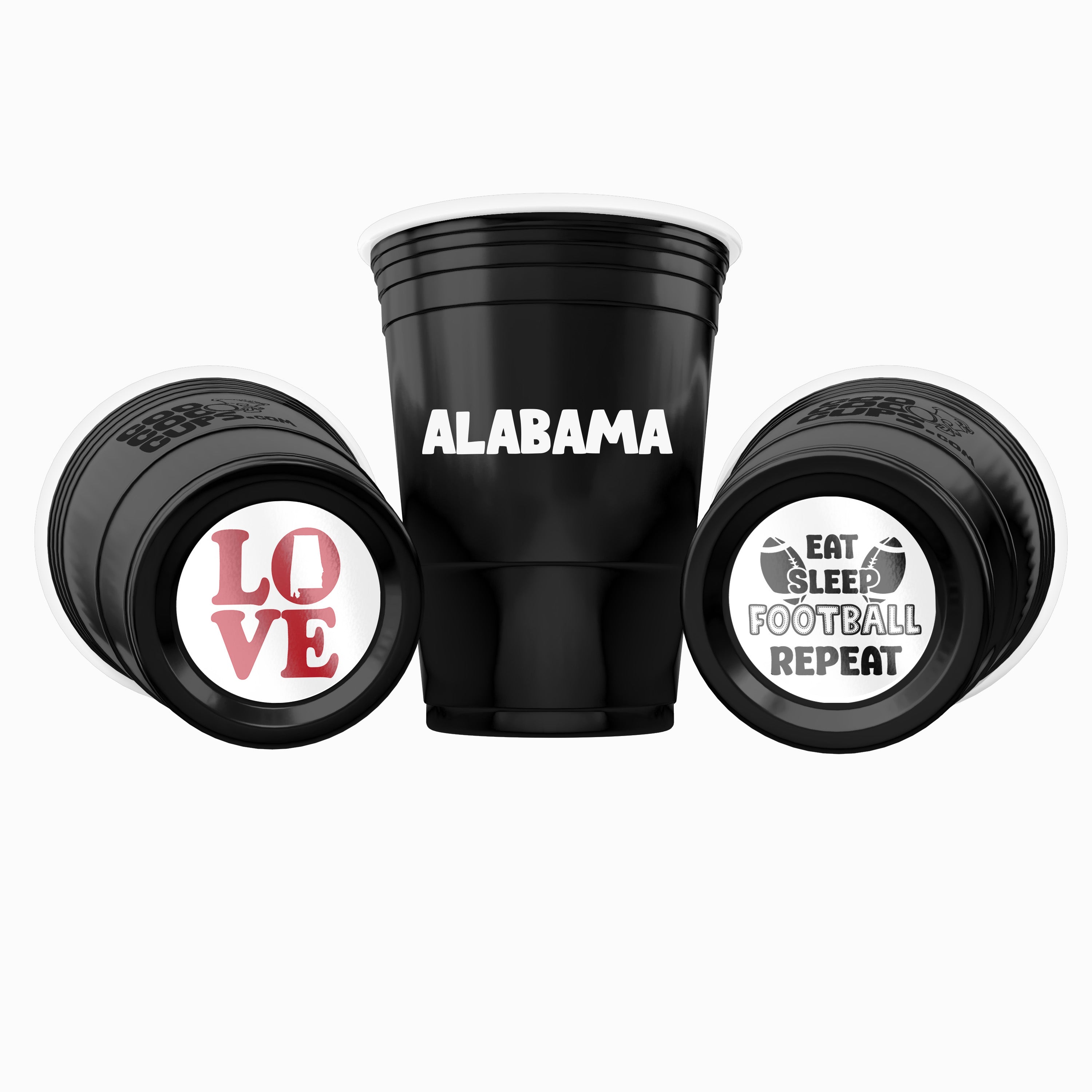 Three black CooCoo Cups® are shown. One displays "Alabama" text, while the other two lie on their sides, revealing bottom stickers featuring “LOVE” with Alabama state icon and a "Eat, Sleep, Football, Repeat" graphic.