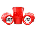 Three red CooCoo Cups® are shown. One displays the logo, while the other two lie on their sides, revealing bottom stickers labeled “Send Nudes” and “Sent Nudes.”
